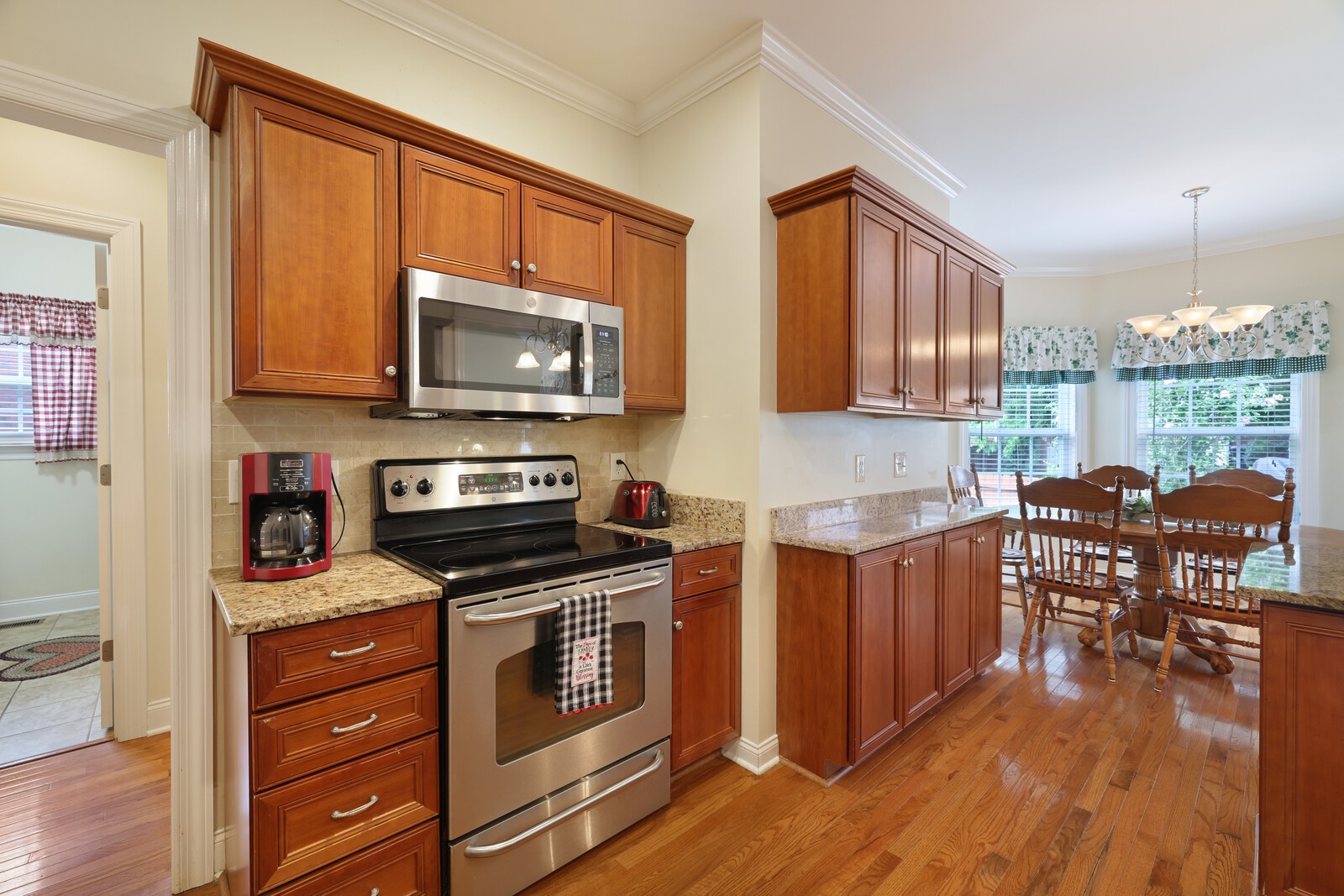 3020 Brookside Path Murfreesboro, TN 37128 - Photo 23 of 59 a kitchen with granite countertop wooden cabinets stainless steel appliances and a wooden floor