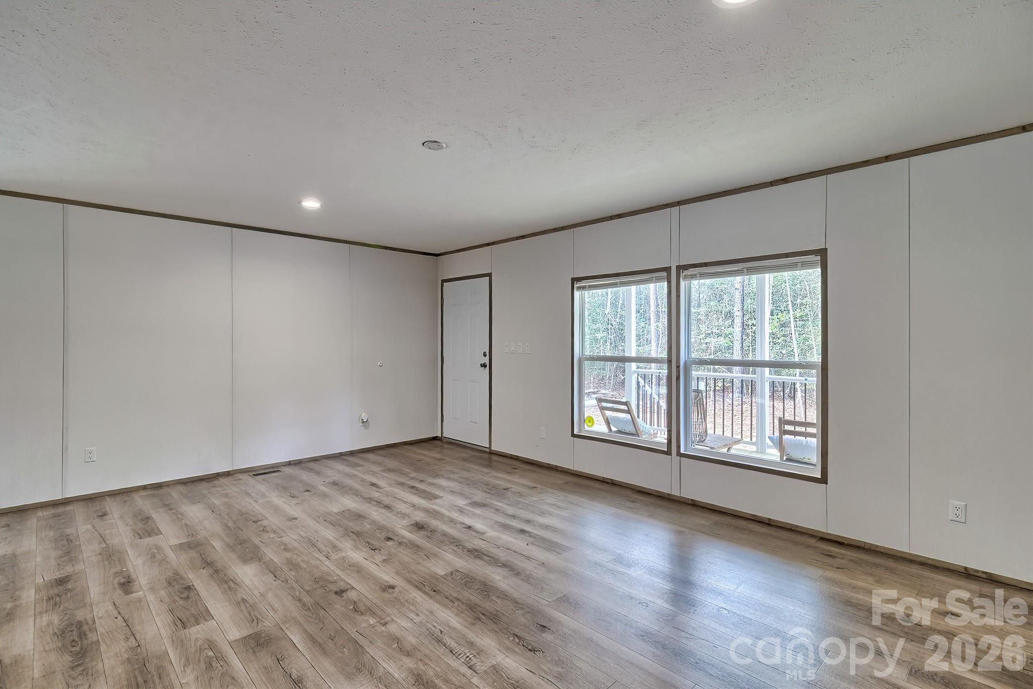 299 Ned Williams Road Kershaw, SC 29067 - Photo 20 of 43 a view of an empty room with wooden floor and a window