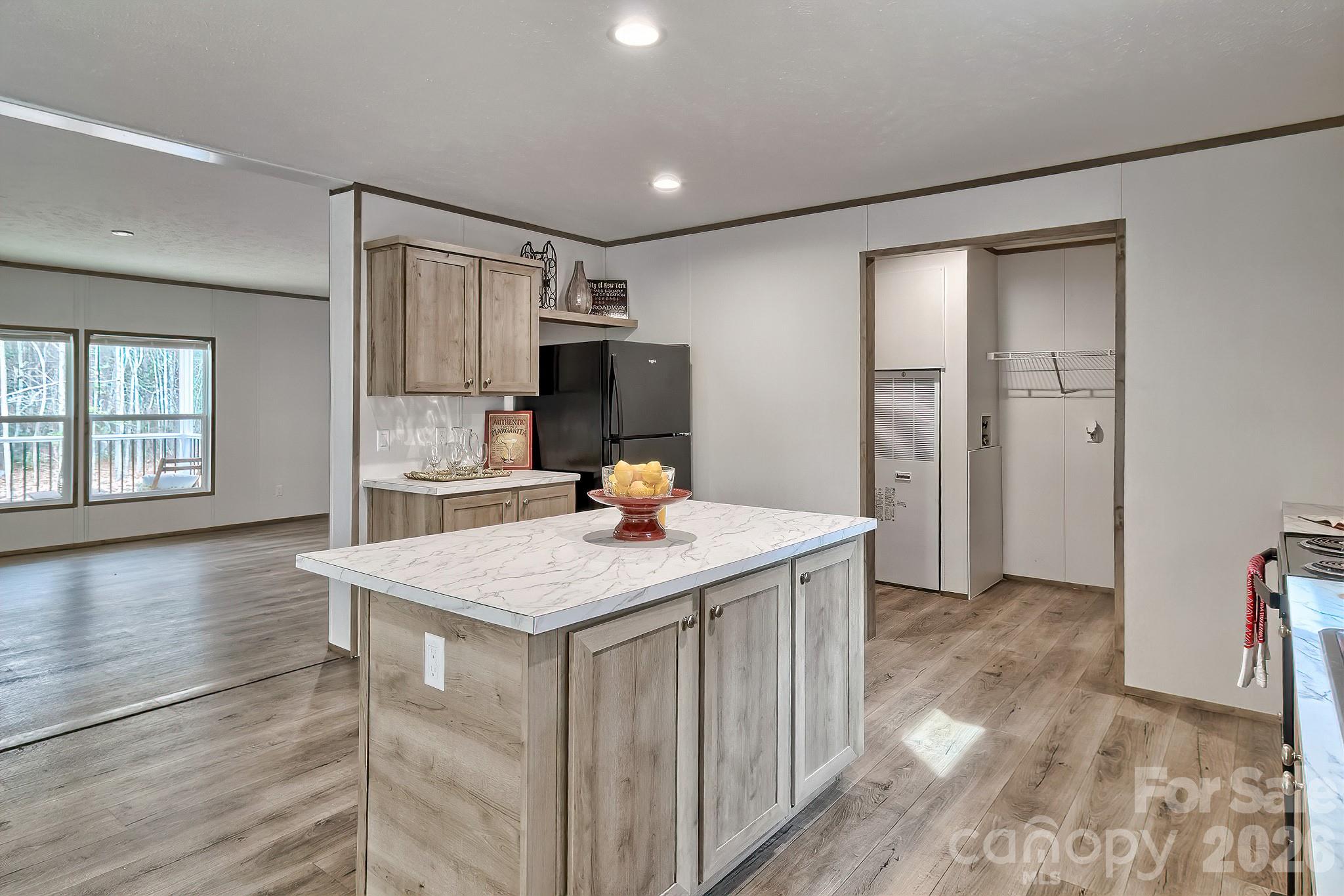 299 Ned Williams Road Kershaw, SC 29067 - Photo 27 of 43 a kitchen with kitchen island sink refrigerator and window