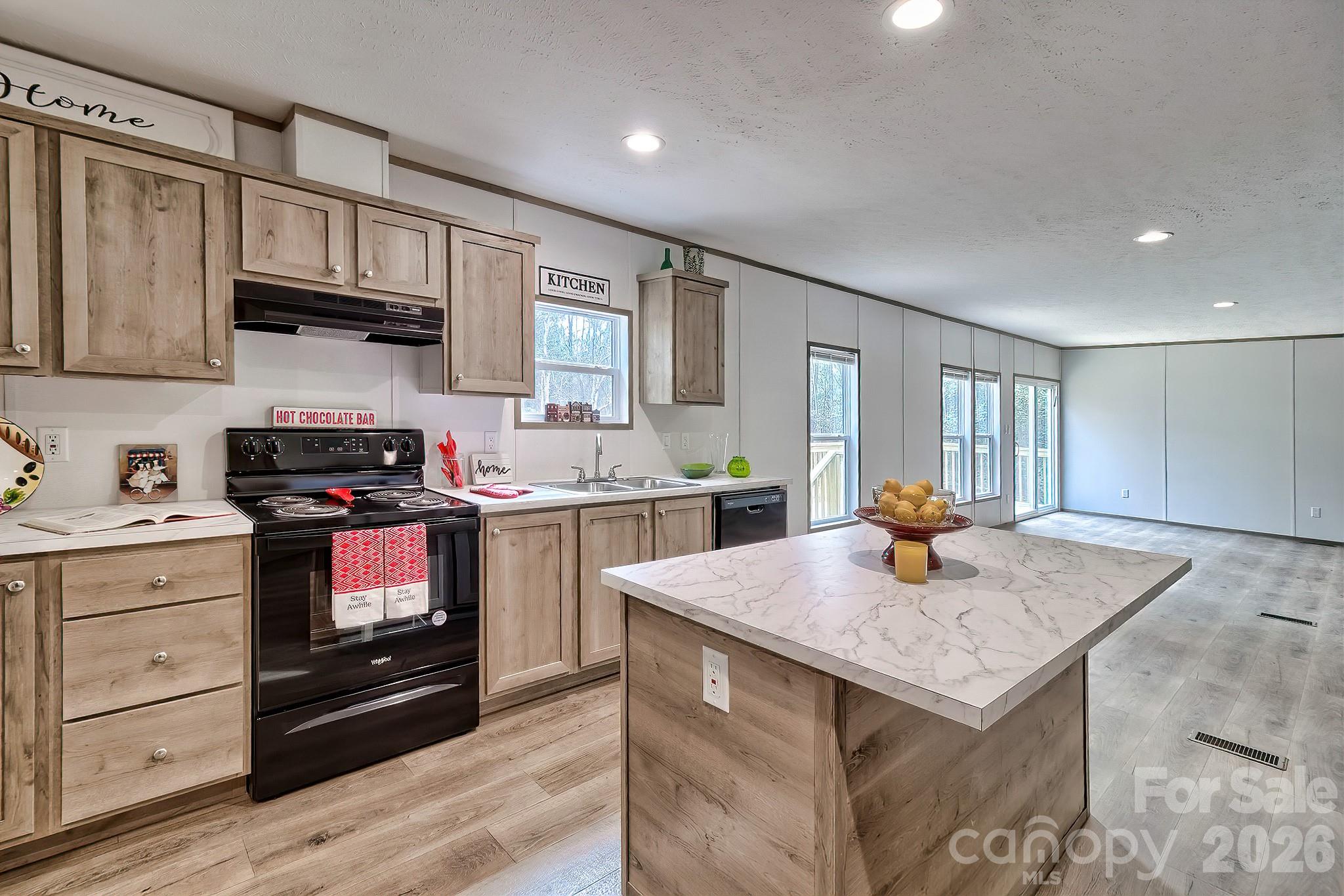 299 Ned Williams Road Kershaw, SC 29067 - Photo 28 of 43 a kitchen with granite countertop wooden cabinets and a stove