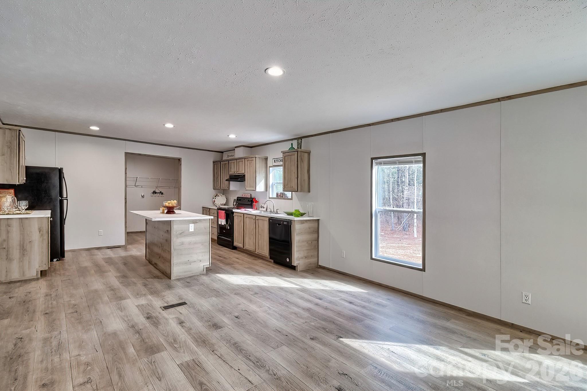 299 Ned Williams Road Kershaw, SC 29067 - Photo 32 of 43 a view of a kitchen with furniture and wooden floor