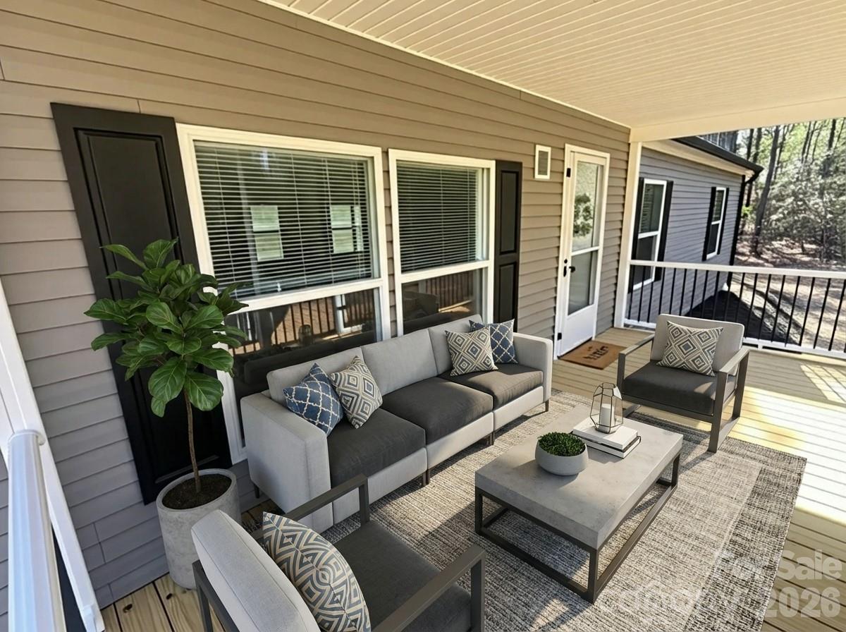 299 Ned Williams Road Kershaw, SC 29067 - Photo 6 of 43 a view of a patio with couches table and chairs and potted plants