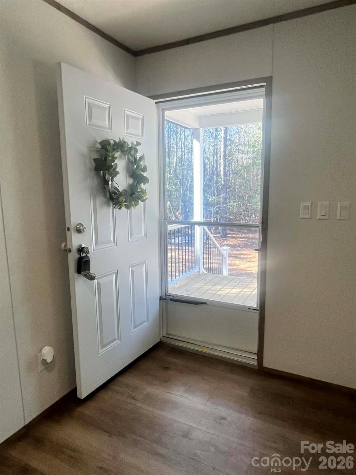299 Ned Williams Road Kershaw, SC 29067 - Photo 7 of 43 a view of an empty room with a window and wooden floor