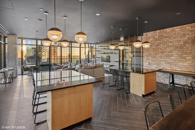 an open kitchen with wooden floor and large window
