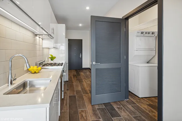 a kitchen with a sink and refrigerator