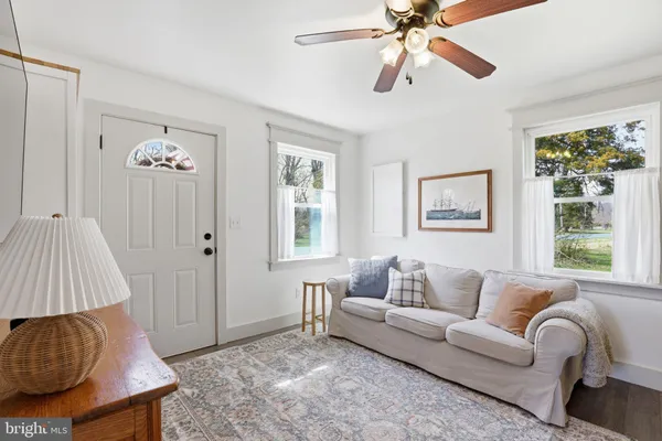 a living room with furniture a dining table and a window