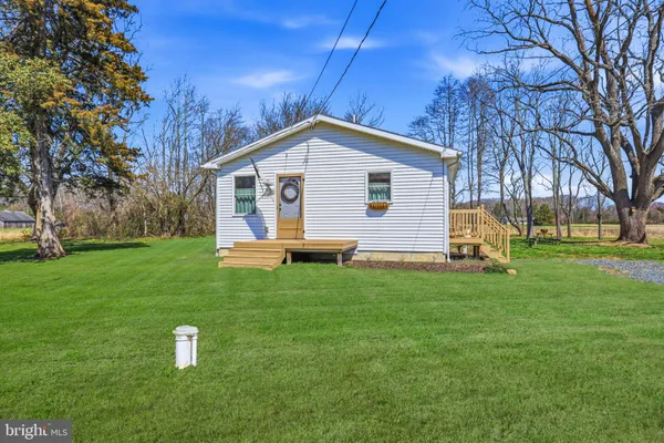 a view of backyard of house with green space