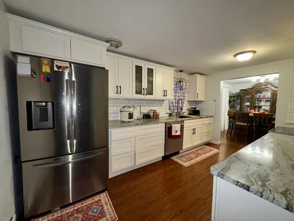 a kitchen with stainless steel appliances a refrigerator sink and microwave