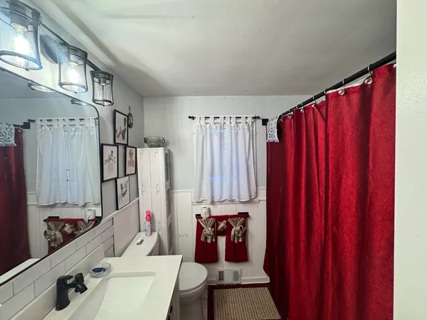 a bathroom with a sink vanity and tub