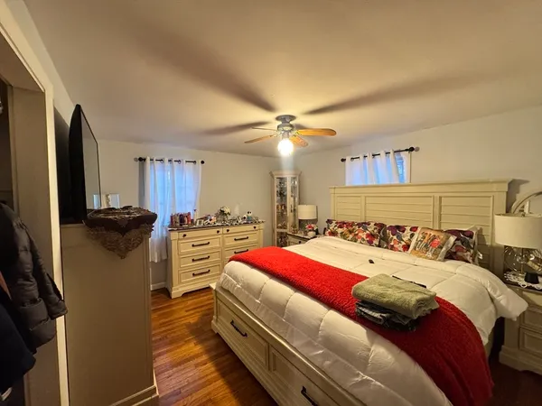 a bedroom with a bed and a television