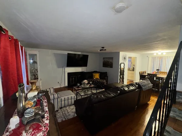 a living room with furniture fireplace and a flat screen tv