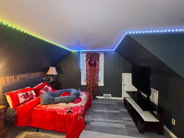 a bedroom with a bed and window