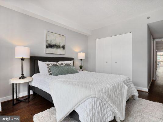 1150 K Street Northwest, Unit 709 Washington, DC 20005 - Photo 22 of 25 a bedroom with a bed and a night stand