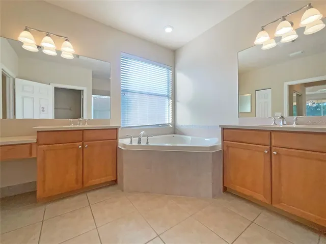 a bathroom with a granite countertop sink a mirror and shower