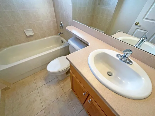 an empty room with a ceiling fan and window