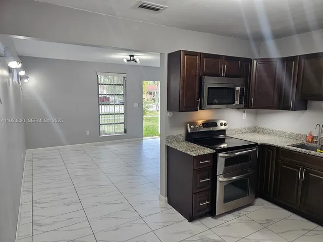 a kitchen with a stove and a microwave