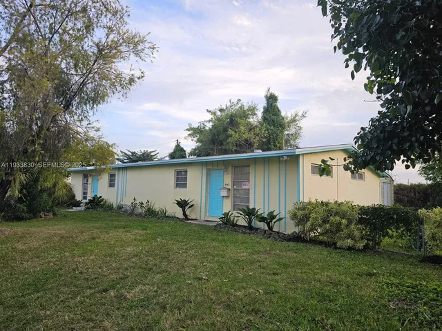 a backyard of a house with table and chairs