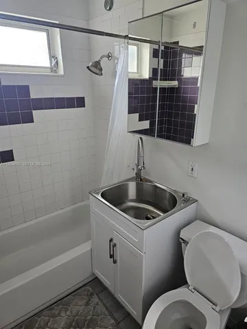 a bathroom with a toilet sink and shower