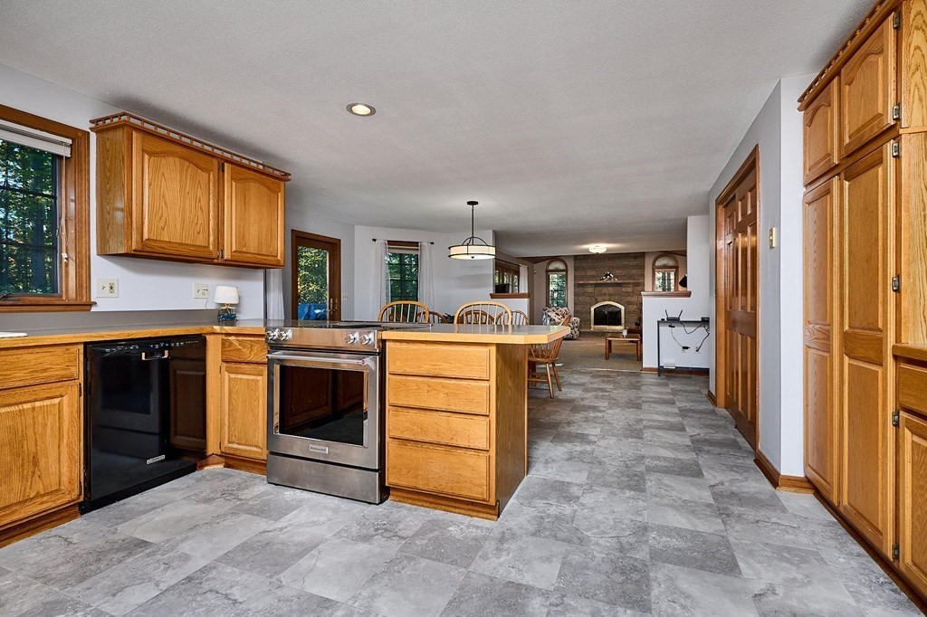 22 Ashley Circle Easthampton, MA 01027 - Photo 11 of 42 a kitchen with stainless steel appliances kitchen island granite countertop a stove top oven a sink dishwasher and a refrigerator