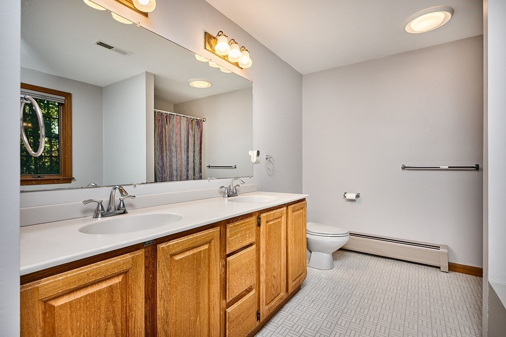 22 Ashley Circle Easthampton, MA 01027 - Photo 27 of 42 a bathroom with a double vanity sink toilet and a mirror