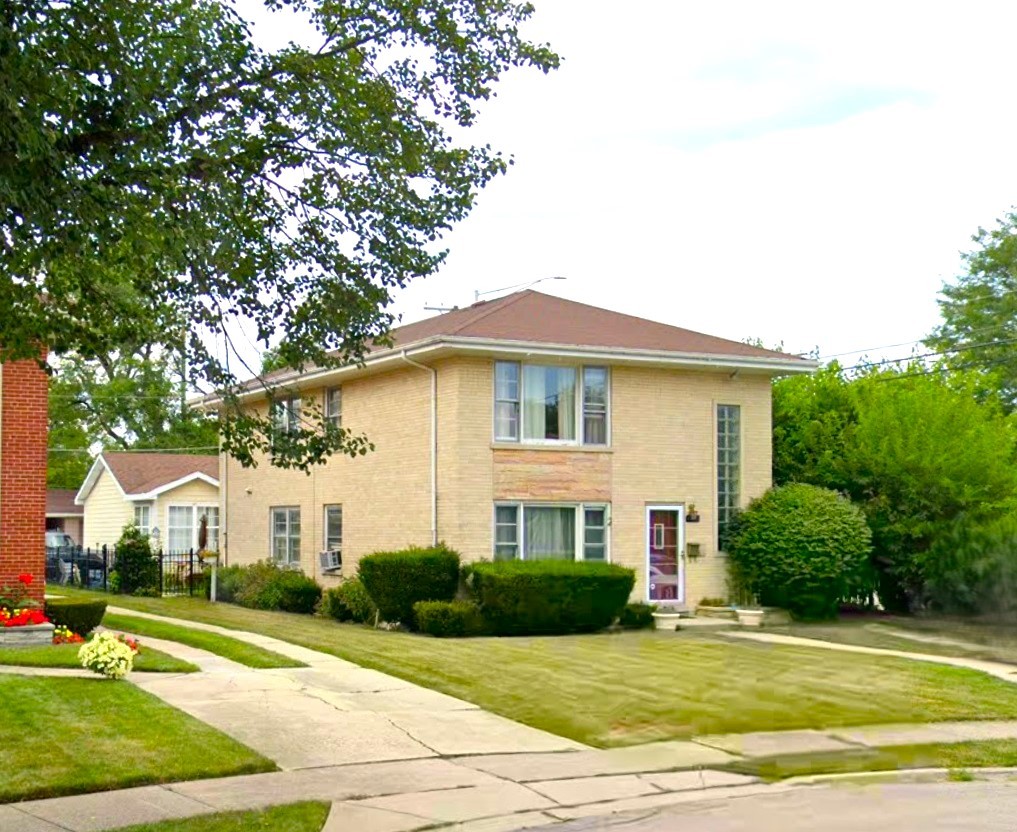 472 Northgate Court Riverside, IL 60546 - Photo 2 of 23 a view of a white house with a yard plants and large tree