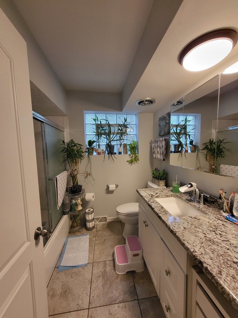 472 Northgate Court Riverside, IL 60546 - Photo 6 of 23 a bathroom with a granite countertop sink mirror and toilet