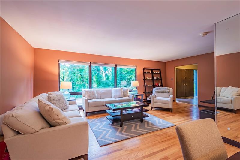 2295 Elmhill Road Pittsburgh, PA 15221 - Photo 5 of 23 Entertaining will be a breeze in the expansive living room with a peaceful, beautiful view, no matter what the season.