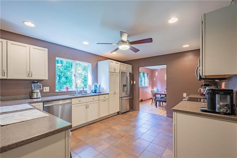 2295 Elmhill Road Pittsburgh, PA 15221 - Photo 9 of 23 Tons of countertop space, a peninsula/breakfast bar and large windows make this a great gathering space for friends or just a warm place for your morning coffee.