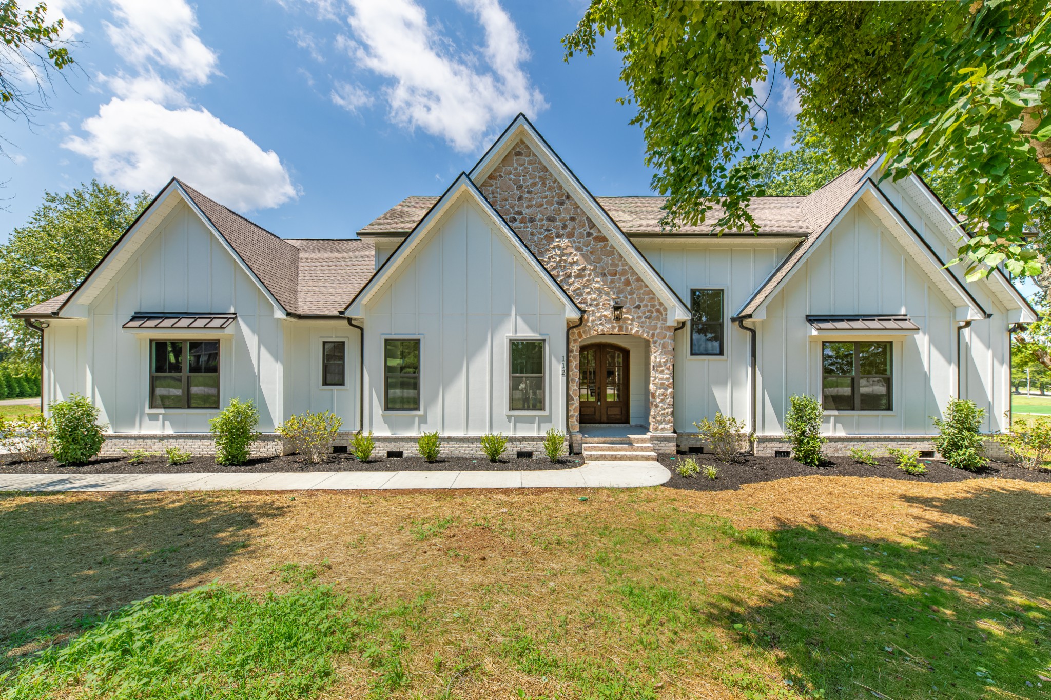 a front view of a house with a yard