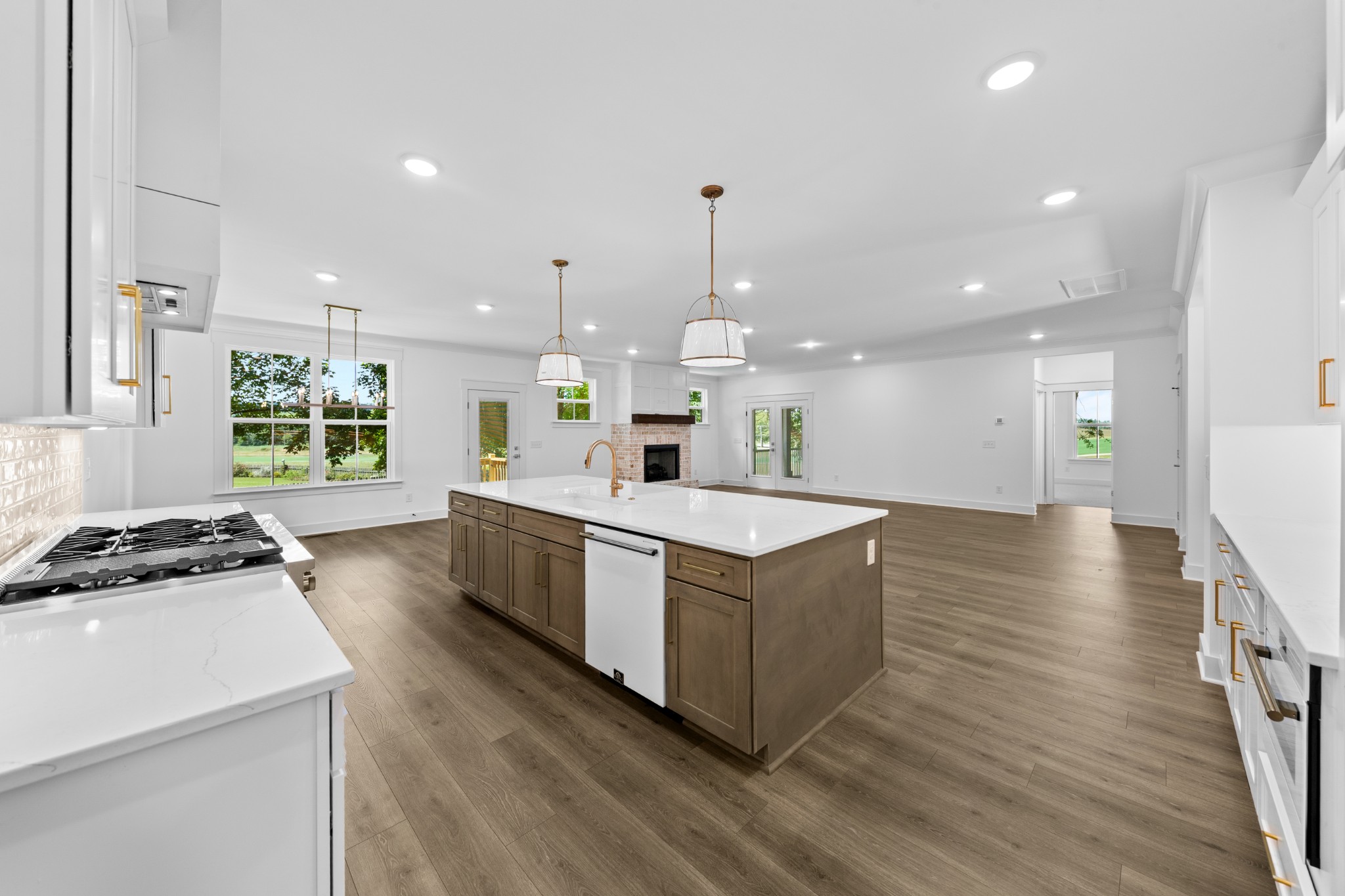 112 Stoneybrook Road Columbia, TN 38401 - Photo 19 of 47 a kitchen with stainless steel appliances granite countertop a stove a sink a refrigerator and a dining table with wooden floor