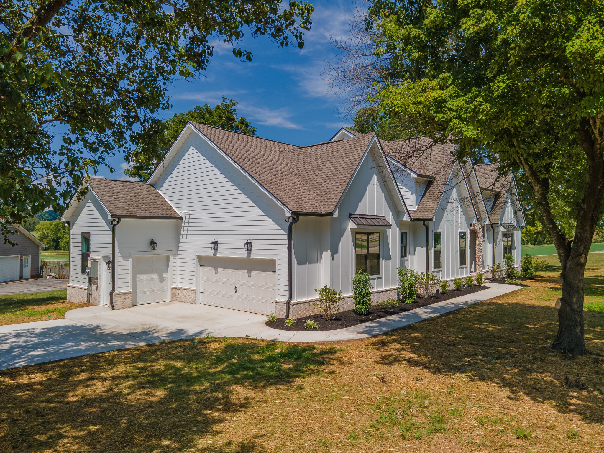 112 Stoneybrook Road Columbia, TN 38401 - Photo 5 of 47 a view of a white house next to a yard with big trees