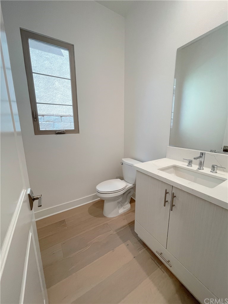 215 Sutters Mill Irvine, CA 92602 - Photo 15 of 57 a bathroom with a granite countertop sink a toilet and a mirror
