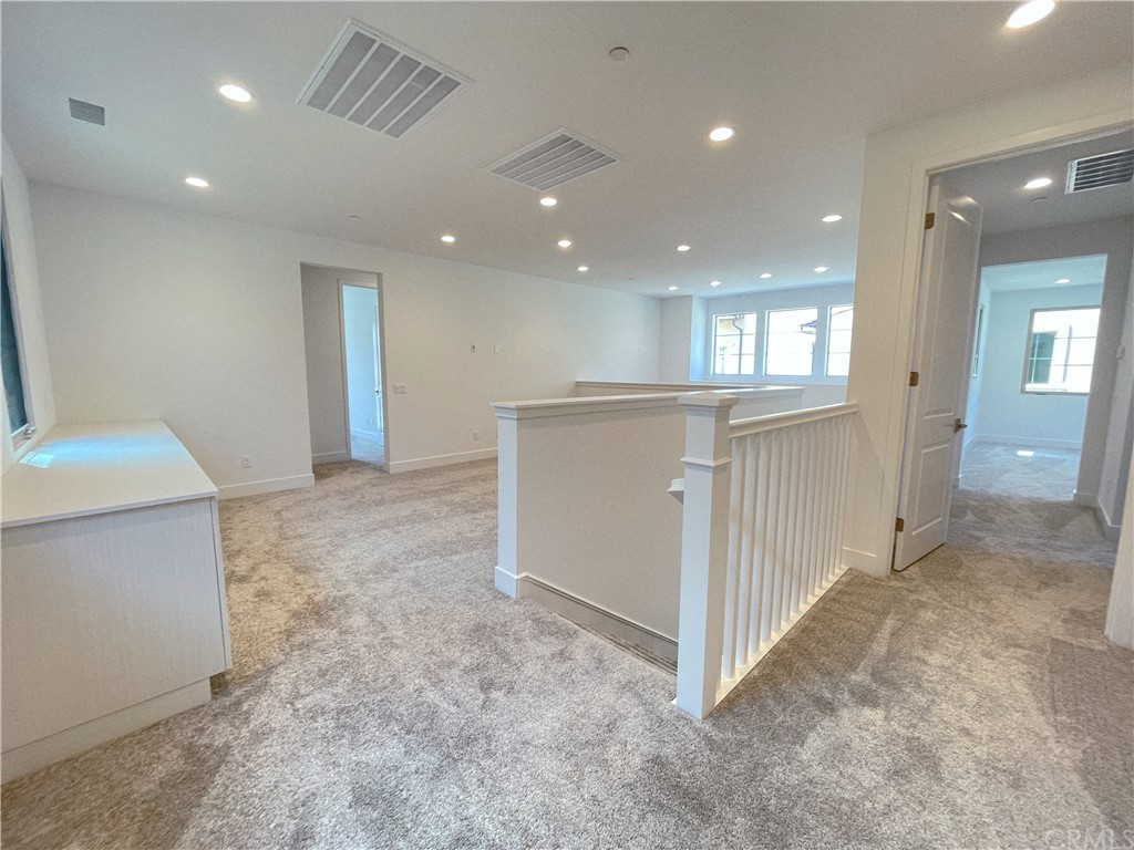 215 Sutters Mill Irvine, CA 92602 - Photo 30 of 57 a view of a hallway with stainless steel appliances granite countertop cabinets and entryway