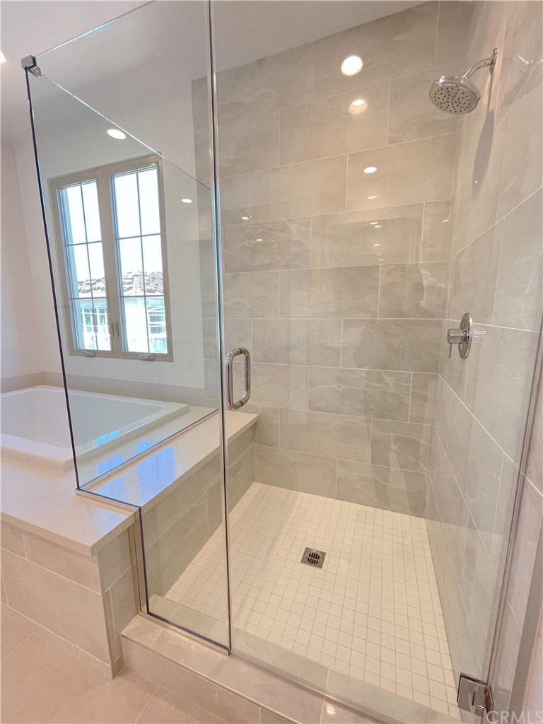 215 Sutters Mill Irvine, CA 92602 - Photo 34 of 57 a bathroom with a bathtub and a shower