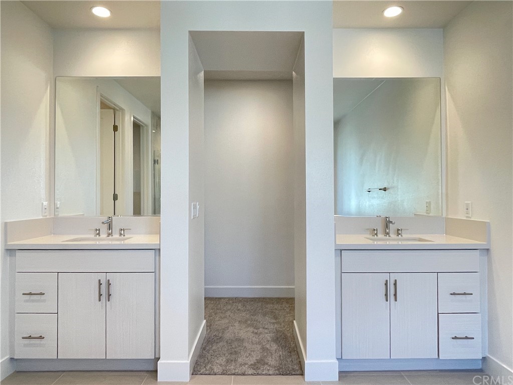 215 Sutters Mill Irvine, CA 92602 - Photo 38 of 57 a bathroom with a sink and a mirror