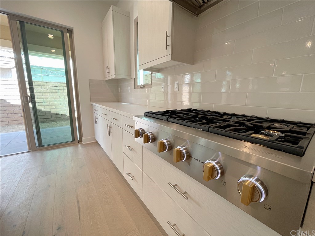 215 Sutters Mill Irvine, CA 92602 - Photo 51 of 57 a kitchen with granite countertop a stove and a sink