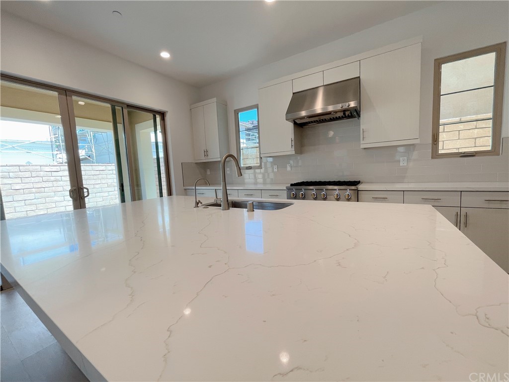 215 Sutters Mill Irvine, CA 92602 - Photo 55 of 57 a kitchen with kitchen island a large window a sink and a counter top space