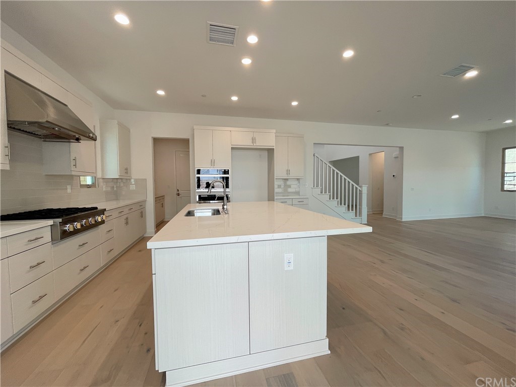 215 Sutters Mill Irvine, CA 92602 - Photo 56 of 57 a kitchen that has a sink and a stove in it