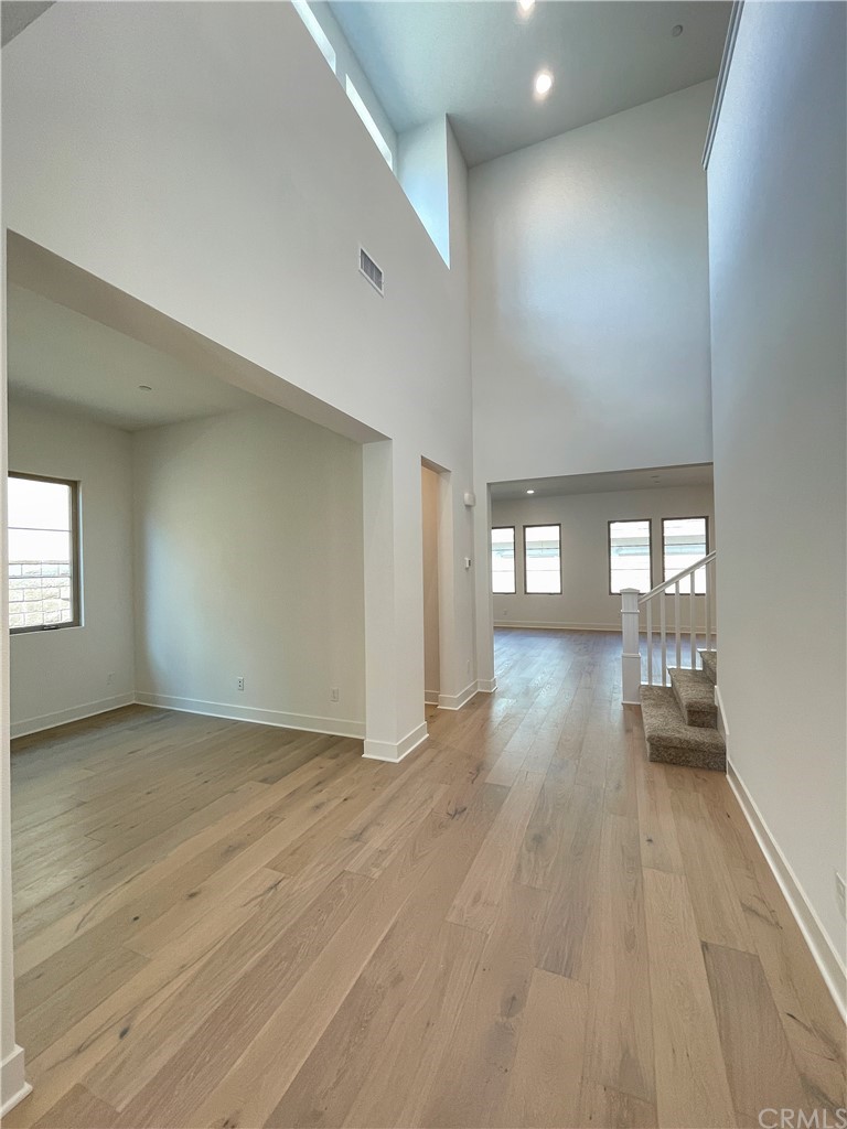 215 Sutters Mill Irvine, CA 92602 - Photo 9 of 57 a view of empty room with wooden floor and window