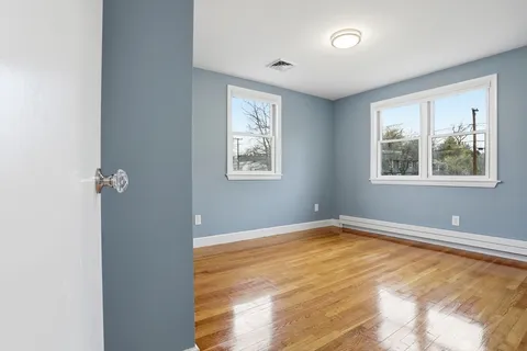 a view of room with window and wooden floor