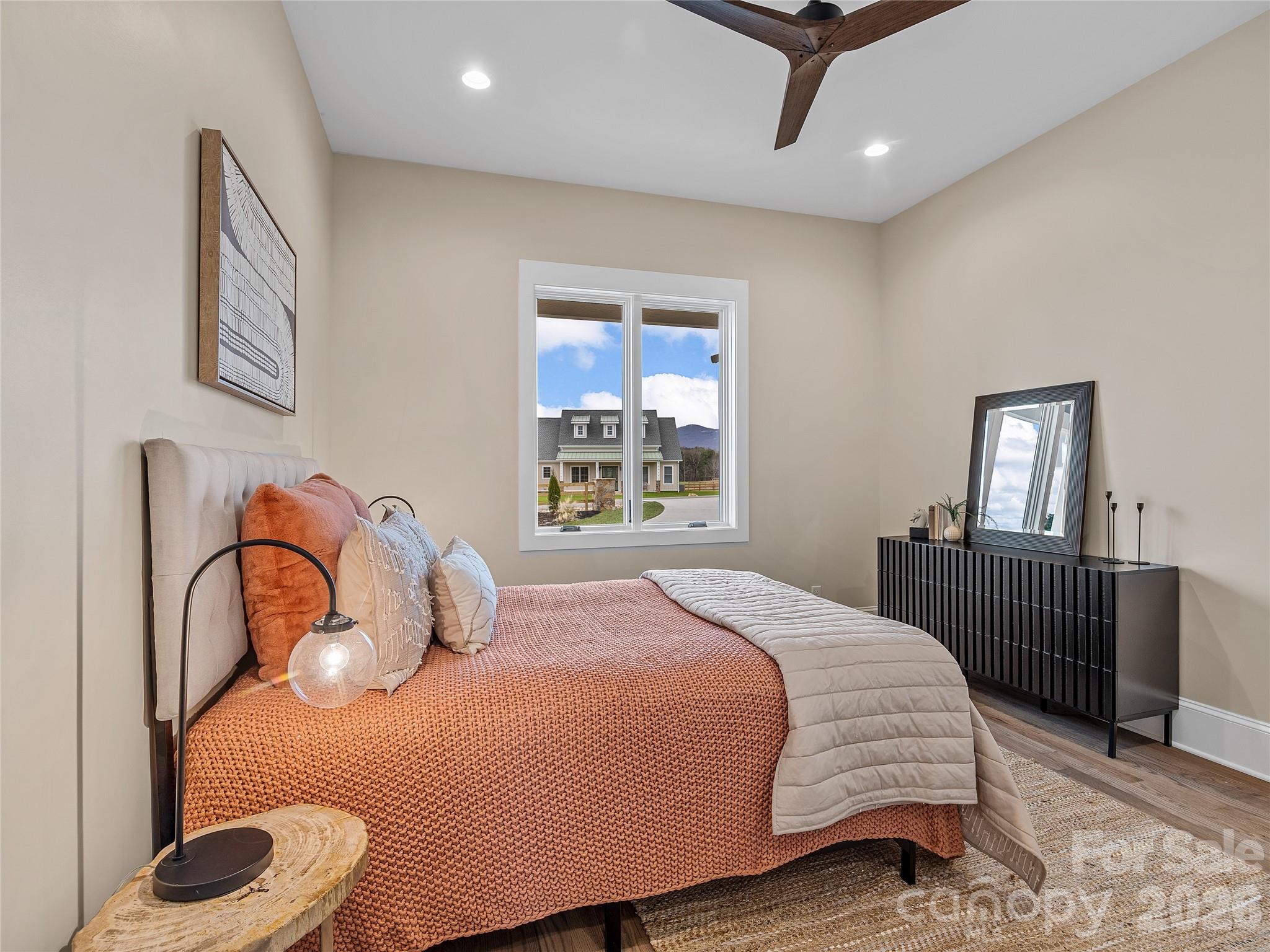 297 Mountain Meadows Lane, Unit 7 Tryon, NC 28782 - Photo 23 of 47 a bedroom with a bed and a window