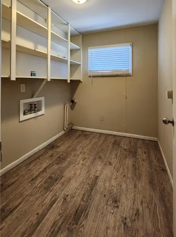 a view of a room with wooden floor and closet