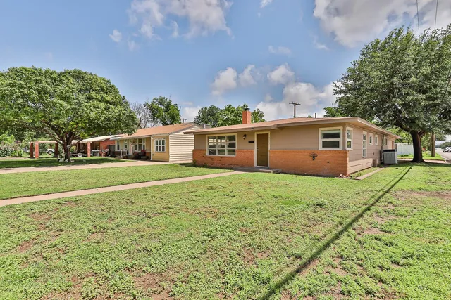 a front view of house with yard and green space