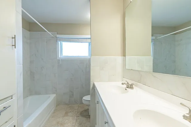 a bathroom with a sink mirror toilet and bathtub