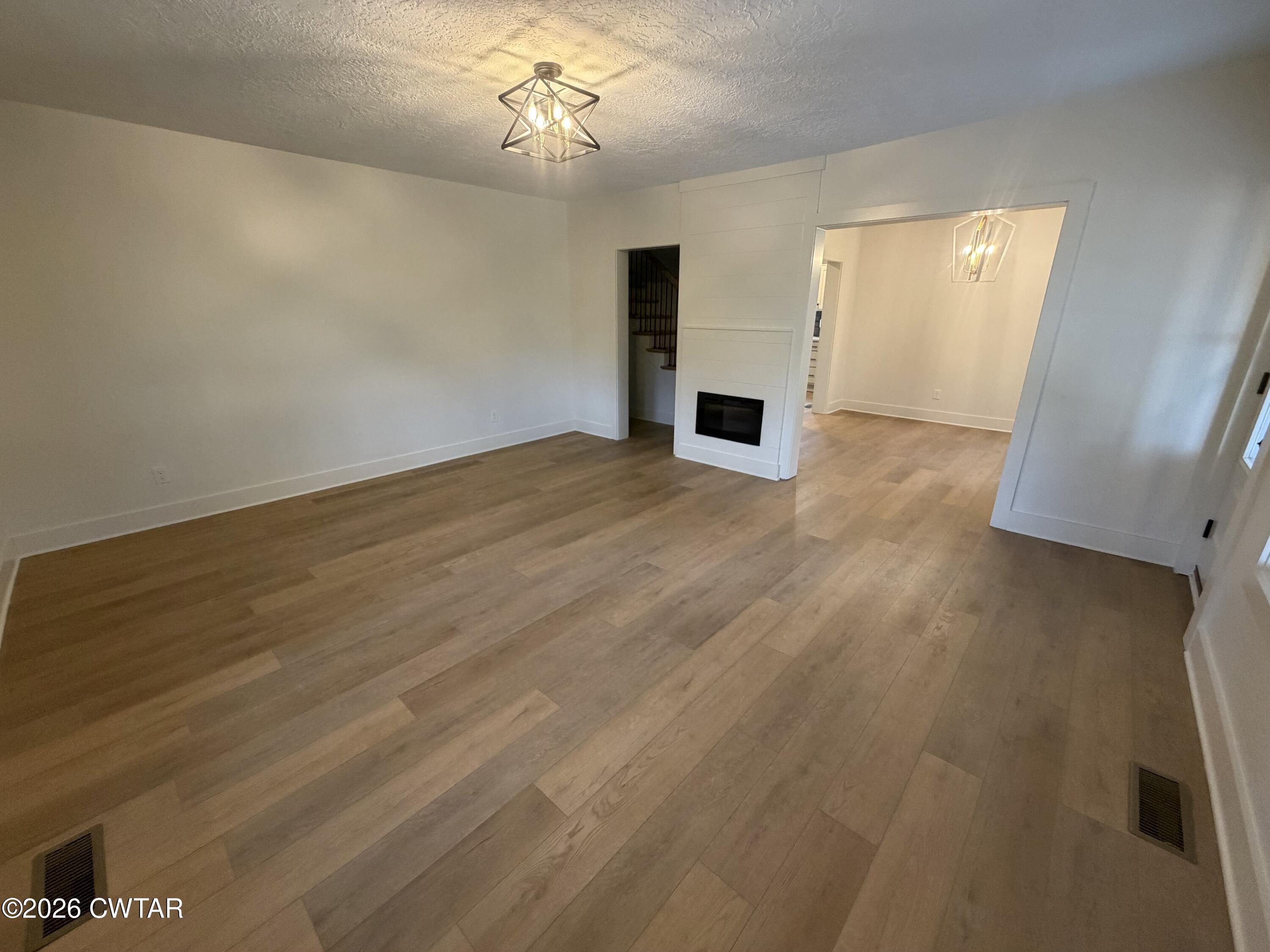 16 Manner Frank Road Milan, TN 38358 - Photo 4 of 25 wooden floor in an empty room with a window