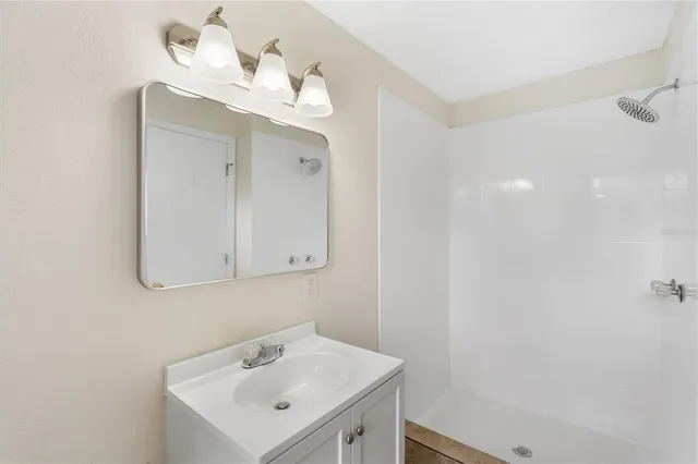 a bathroom with a sink a vanity and a mirror