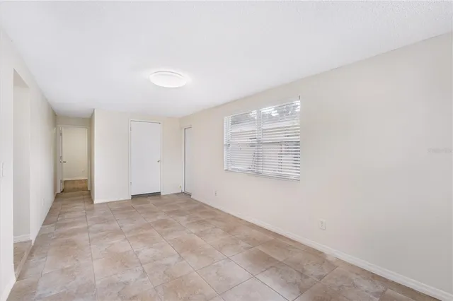 an empty room with windows and entrance