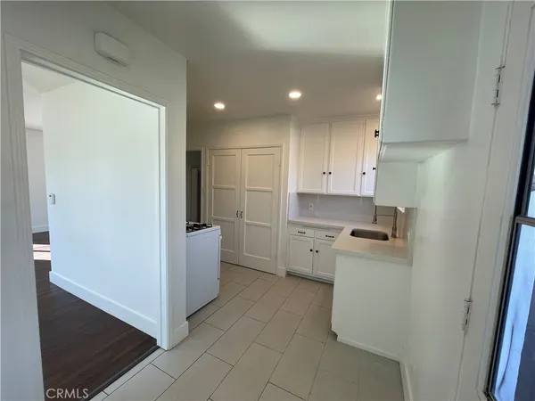 a kitchen with a refrigerator sink stove and cabinets
