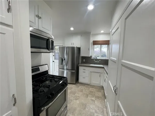 a kitchen with a refrigerator stove and microwave