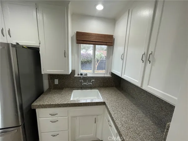 a kitchen with a refrigerator and a sink